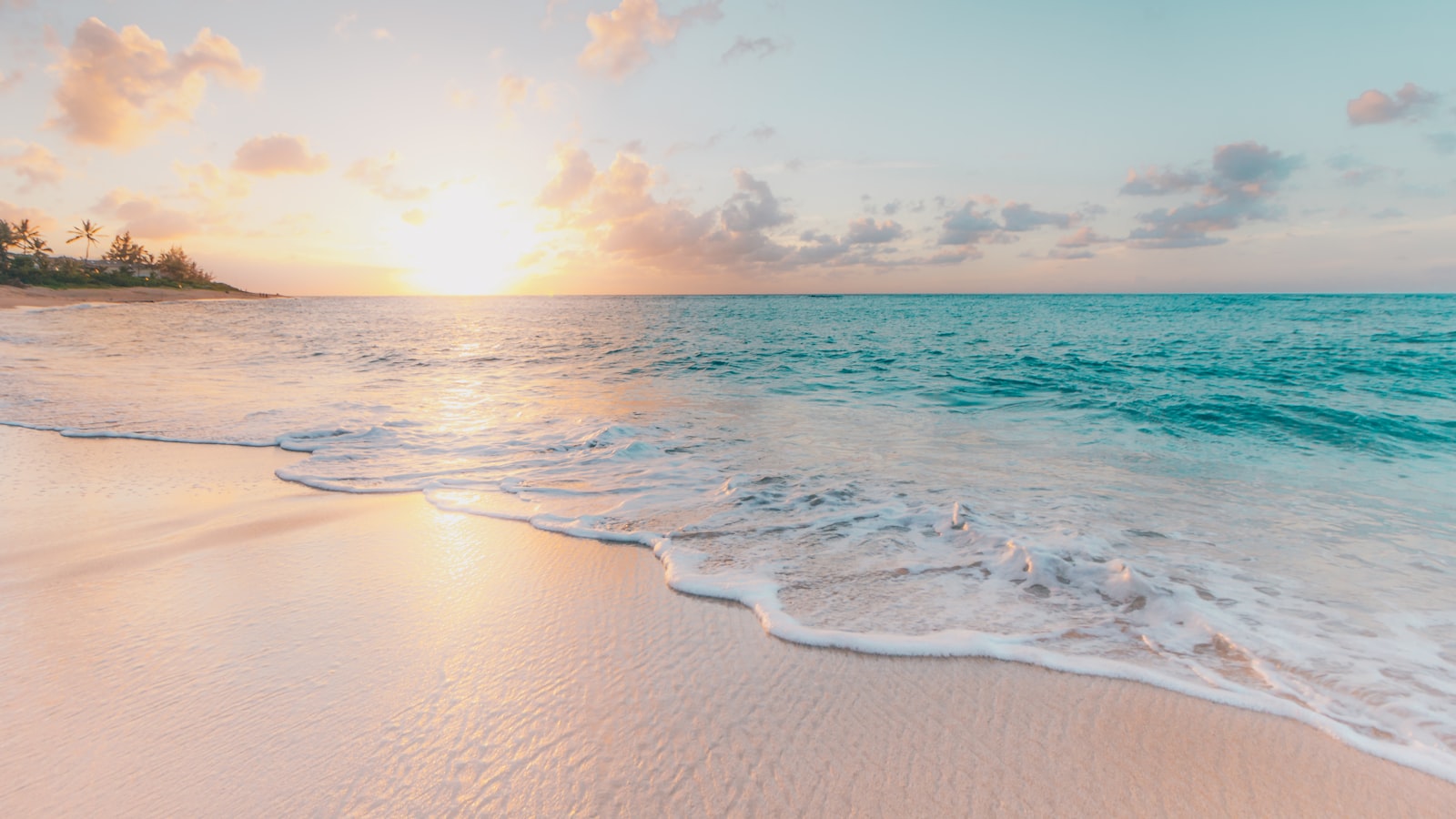Traveler standing on a beach looking toward the horizon