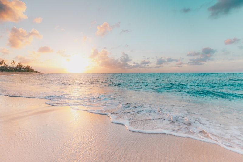 Traveler standing on a beach looking toward the horizon
